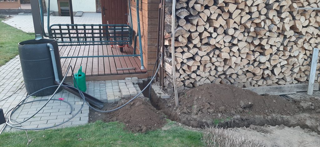 Trench for underground power cable running across yard