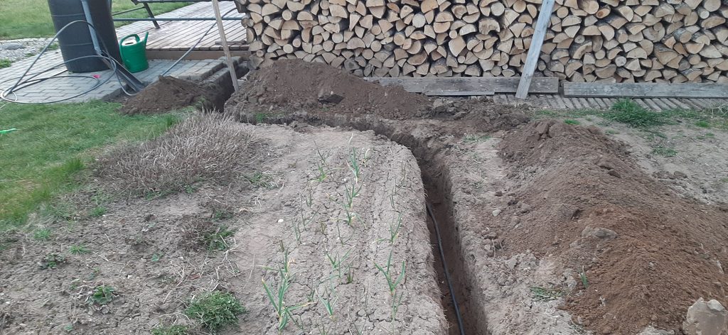 Underground electrical cable trench leading to greenhouse