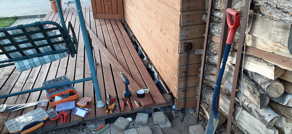 Outdoor electrical socket installed beside garage for garden use